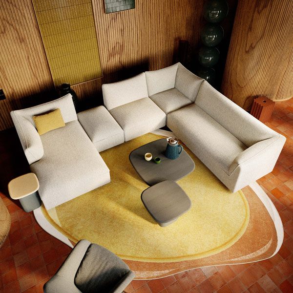 Moderne Pode hoekbank in lichte stof op een warm interieur met ronde vormen en design salontafels
