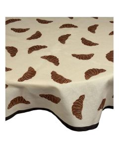 Beige tafelkleed met bruine croissantprint over tafel met donkere rand langs de onderzijde
