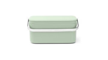 Lichtgroen Brabantia aanrecht afvalbakje met een strak design en roestvrijstalen handvat.