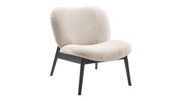 Fauteuil Krelani van Inhouse, schuin van voren gezien, met zachte bekleding en een zwart houten frame.