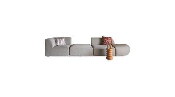 Jax elementenbank in lichtgrijze stof, opgebouwd uit vier modulaire delen met kussens en een bijzettafel op witte achtergrond.