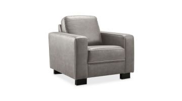 Een grijze fauteuil met zwart houten pootjes, schuin van voren. Met een grijze stoffering en los zit- en rugkussen.