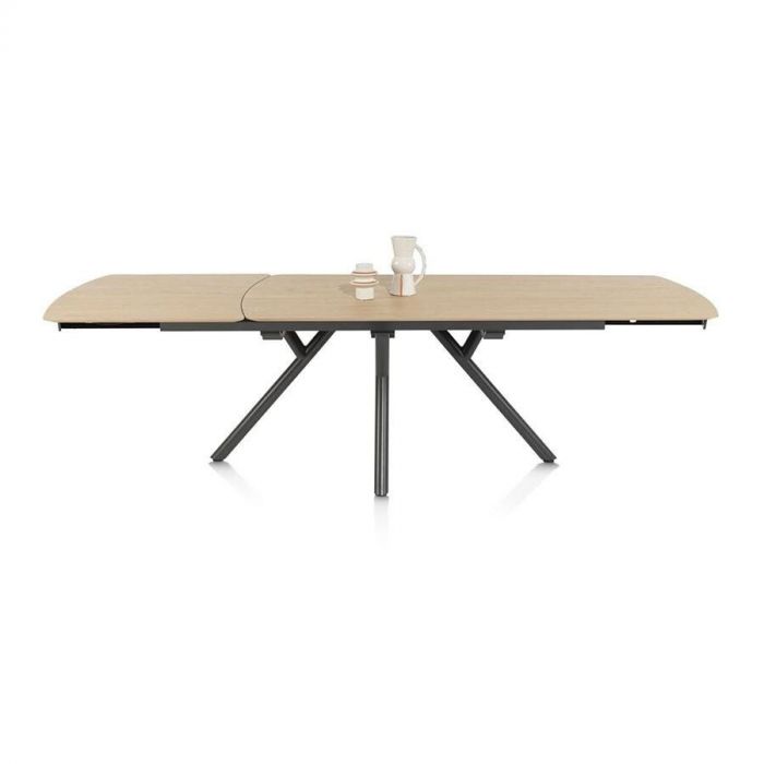 Uitschuifbare eettafel Novello van XOOON met natuurlijk houten blad en zwart metalen poten, volledig uitgeschoven.