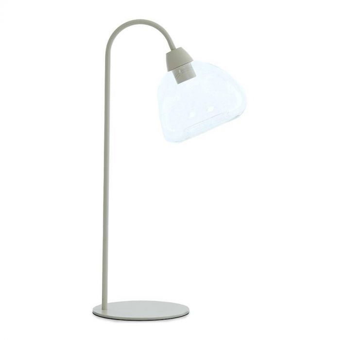 Tafellamp Taveta gezien recht van voren, met een crèmekleurige metalen voet en een transparante glazen kap.