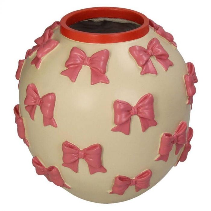 Kersten vaas met roze strikken op een ronde crème ondergrond.