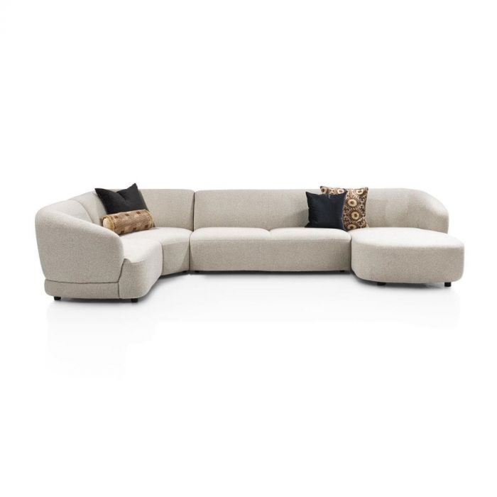 Designsofa Cervo in beige stof met afgeronde vormen en modulaire opstelling, schuin vooraanzicht.