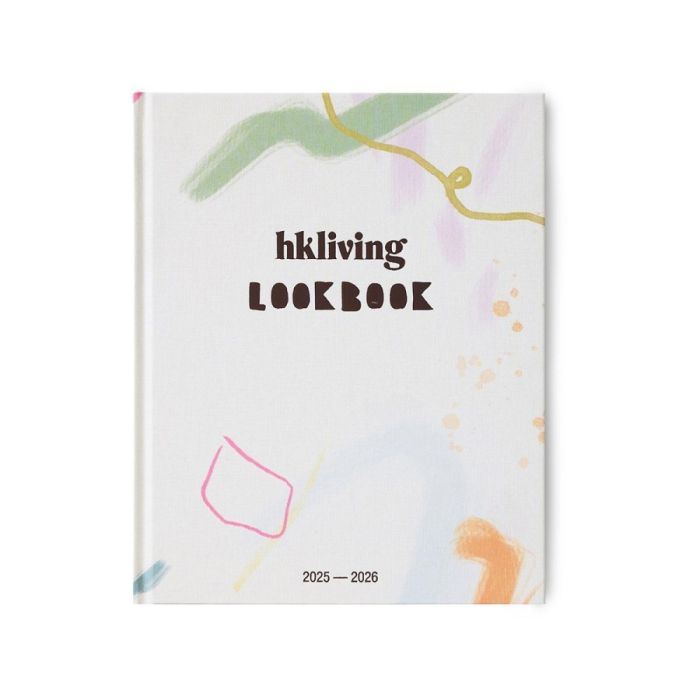 Voorkant van het HKLiving Lookbook 2025–2026 met kleurrijke abstracte illustraties op een witte achtergrond.