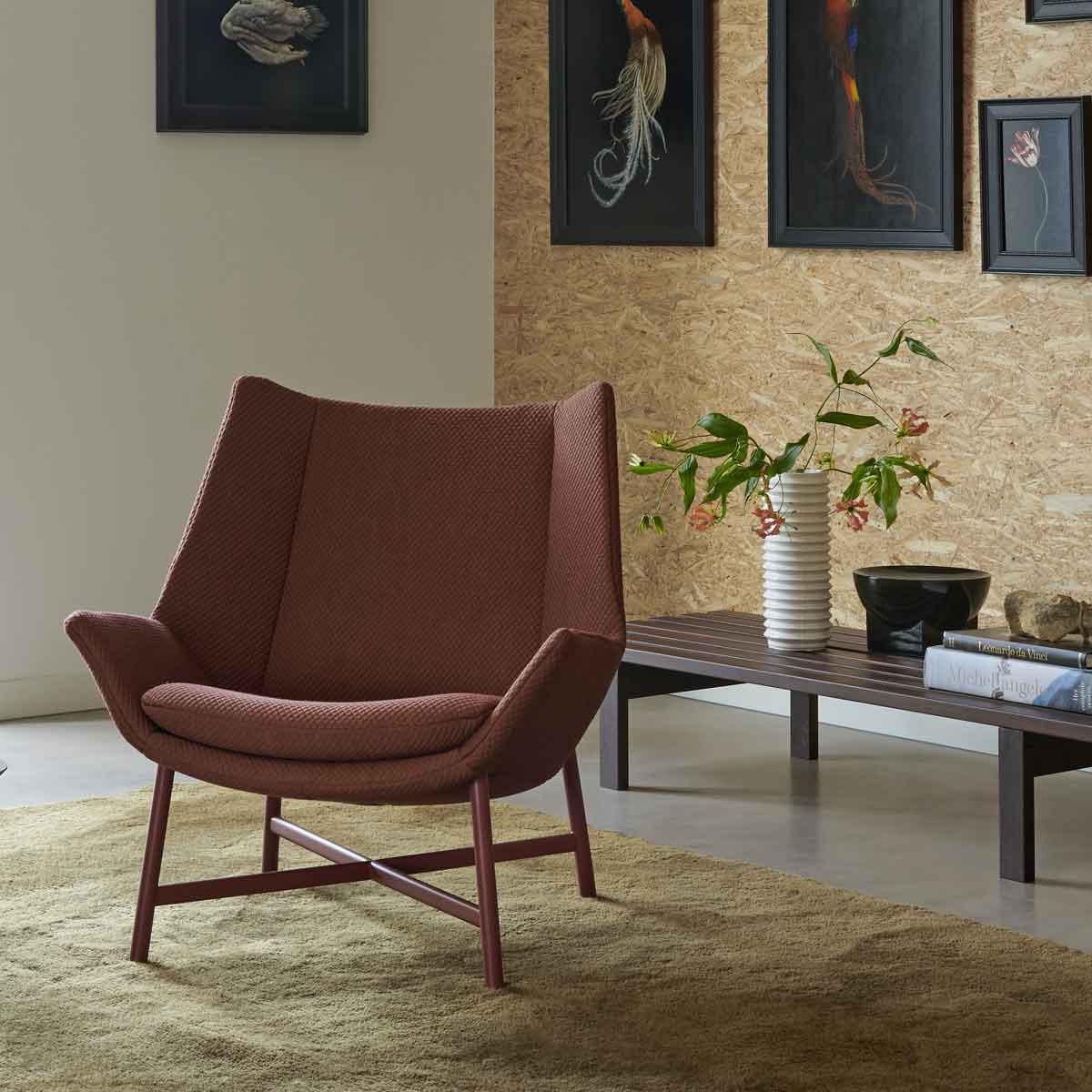 Gele hoekbank met chaise longue van Gelderland Design op roodbruin vloerkleed in moderne woonkamer met glazen salontafel en strakke wandlampen