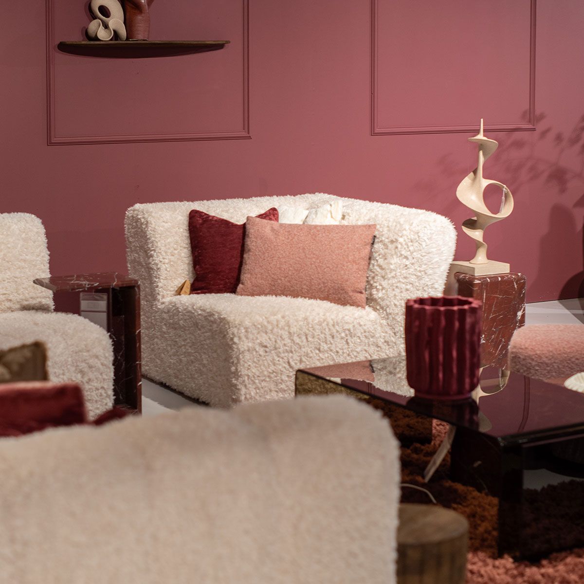 Drie hanglampen met gevouwen bruine glazen kappen hangen voor een raam