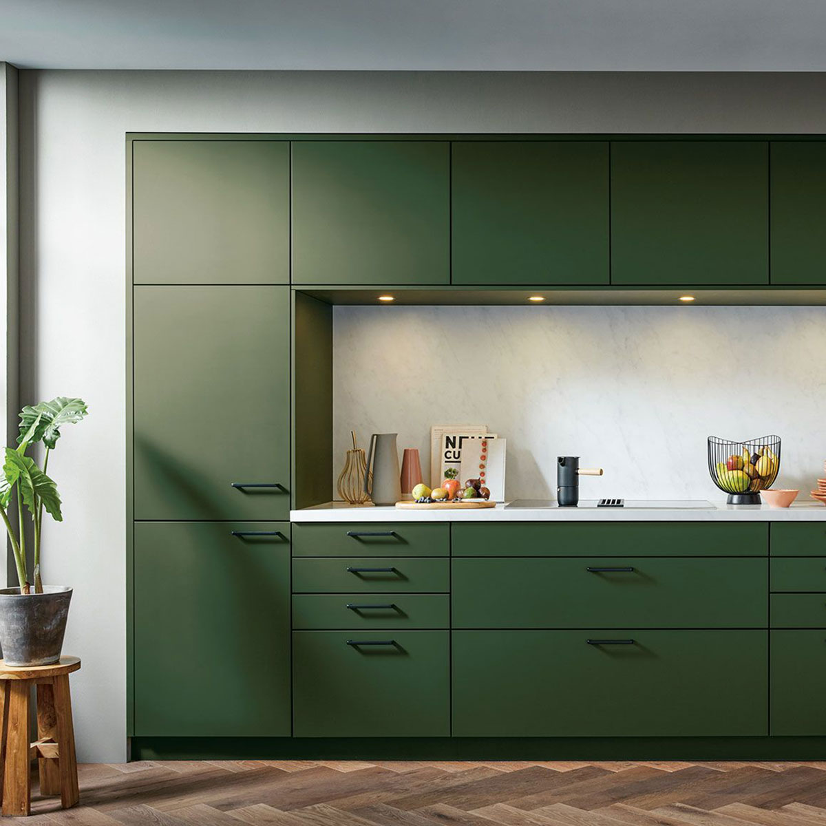 Moderne mosgroene keuken met marmeren achterwand, houten vloer en witte werkblad