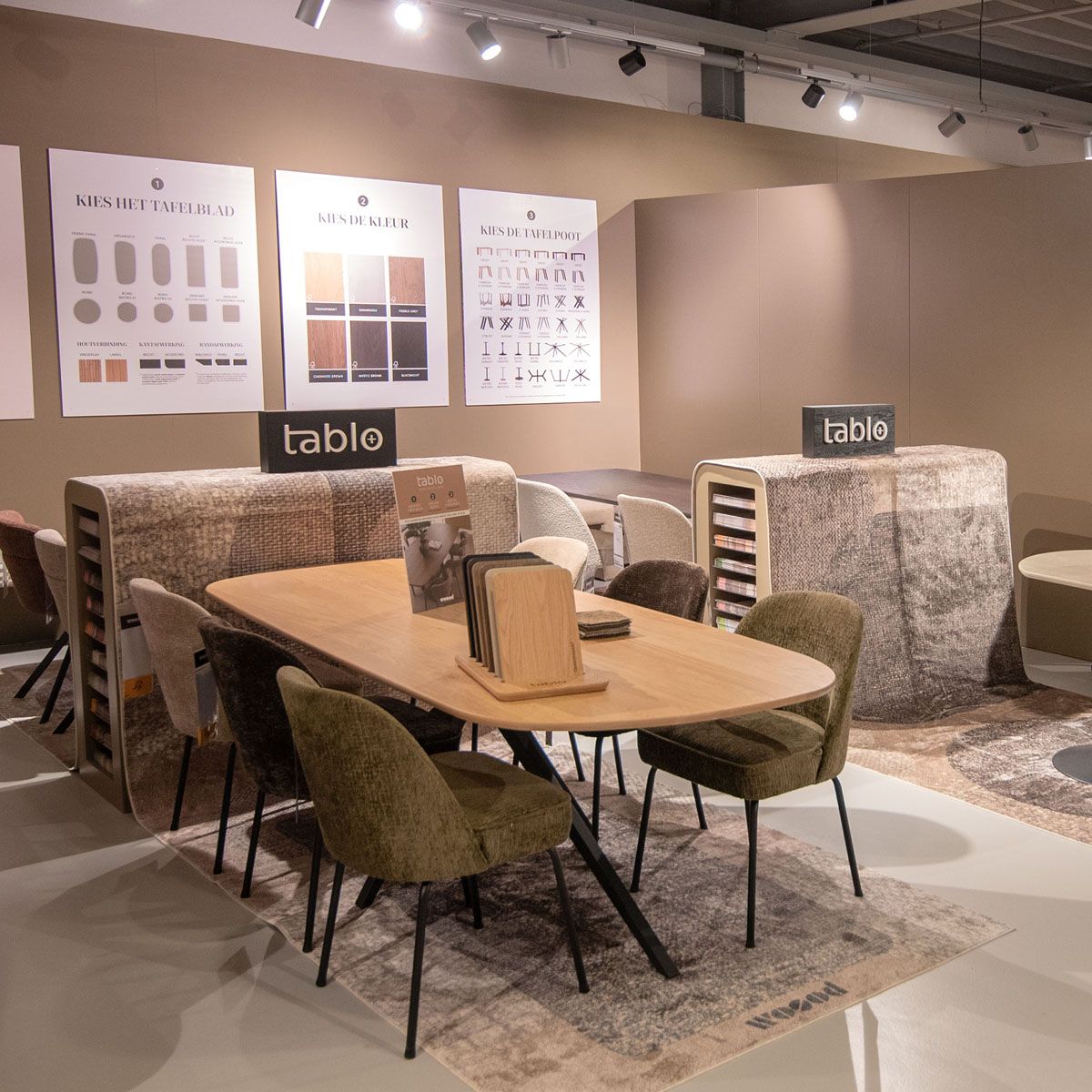 Woood showroom met houten eettafel met groene en bruine eetkamerstoelen met het tablo tafelconcept